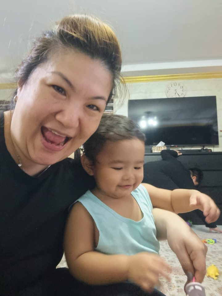 Happy little one in Aunty Jade's care